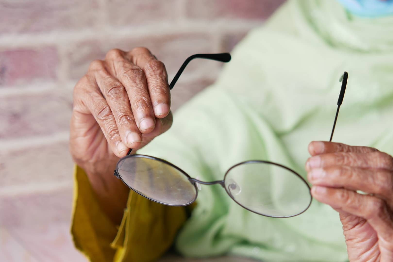person holding black framed eyeglasses