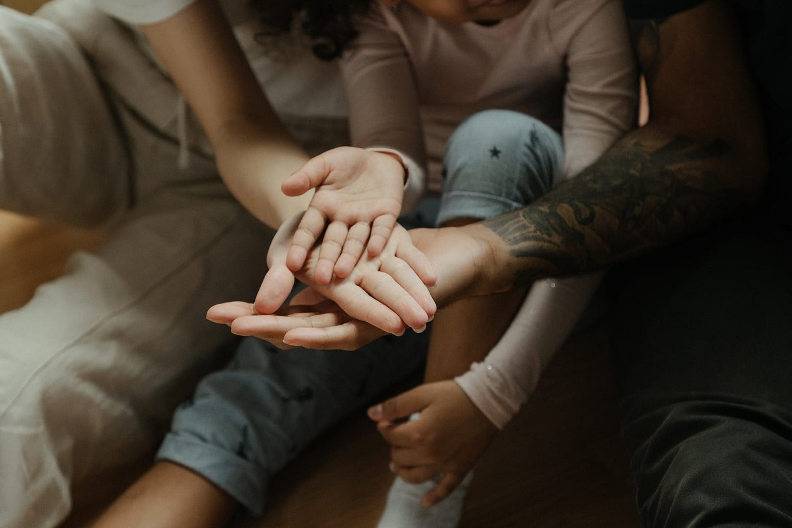 man in gray shirt holding womans hand