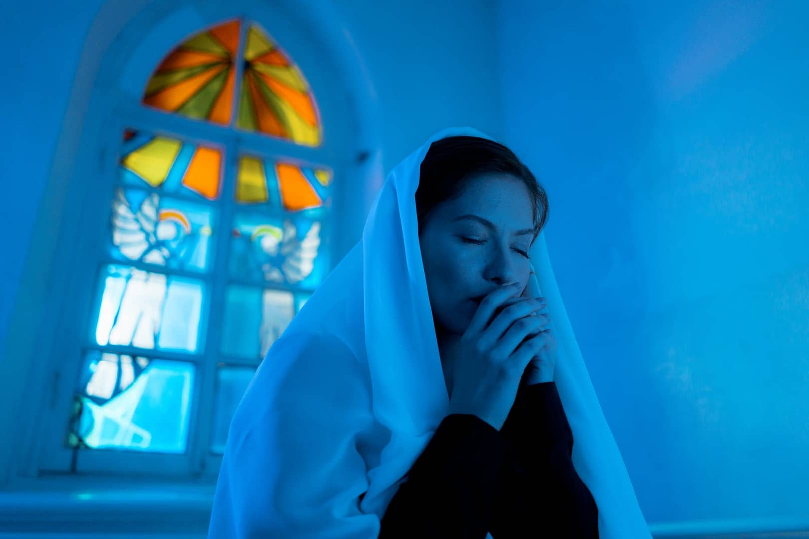 woman in white hijab covering her face