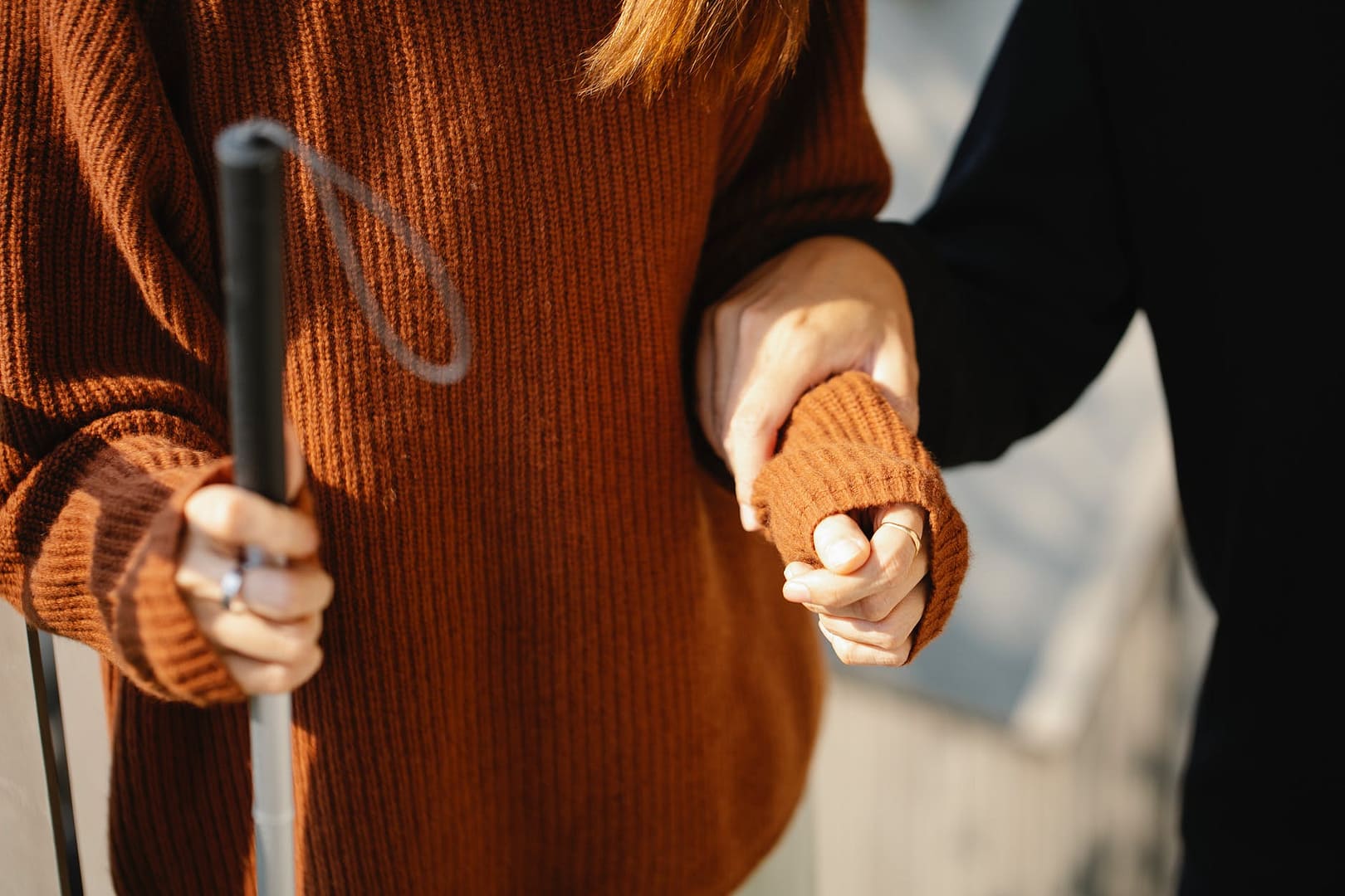photo of man holding on woman s arm