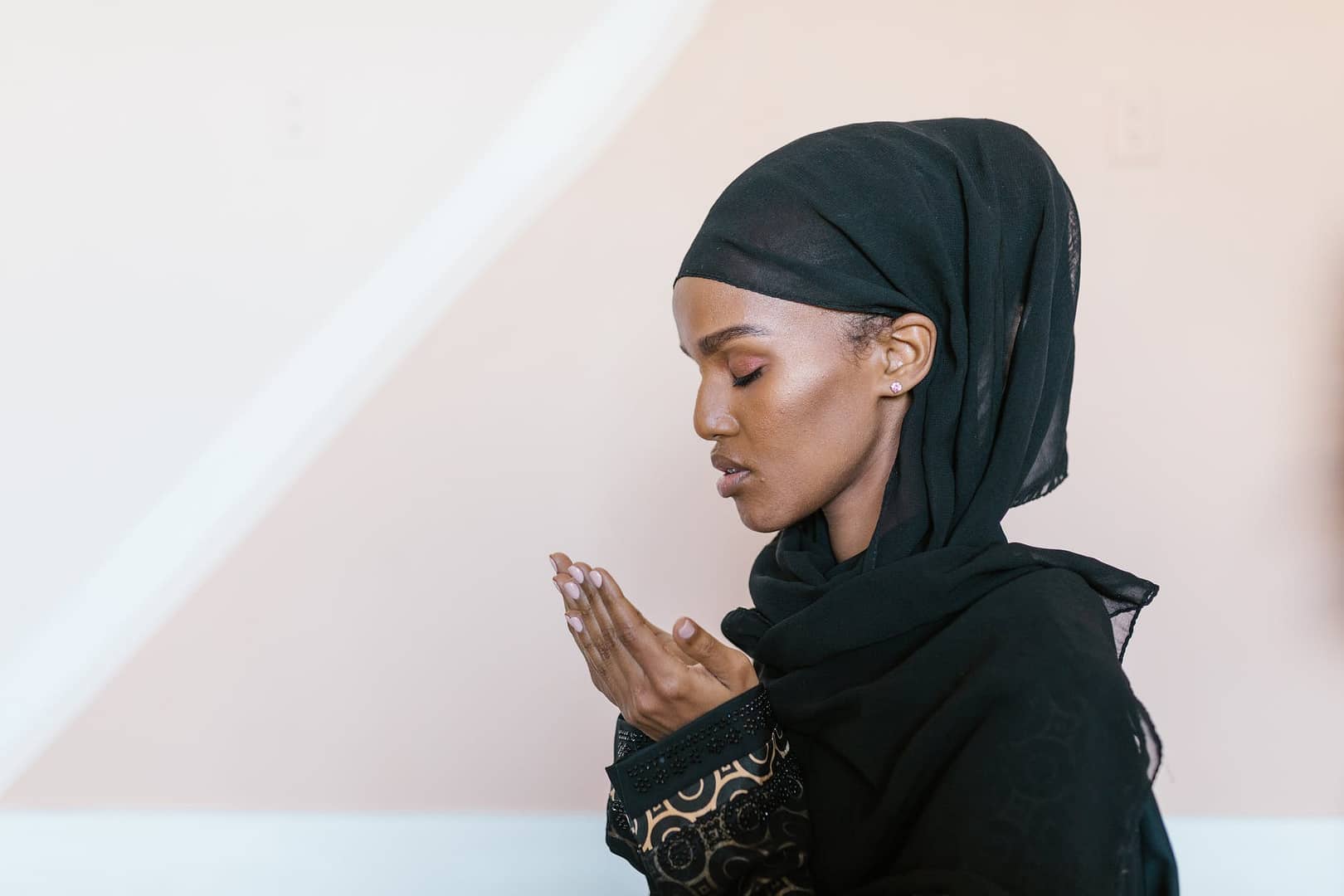 woman in black hijab covering her face