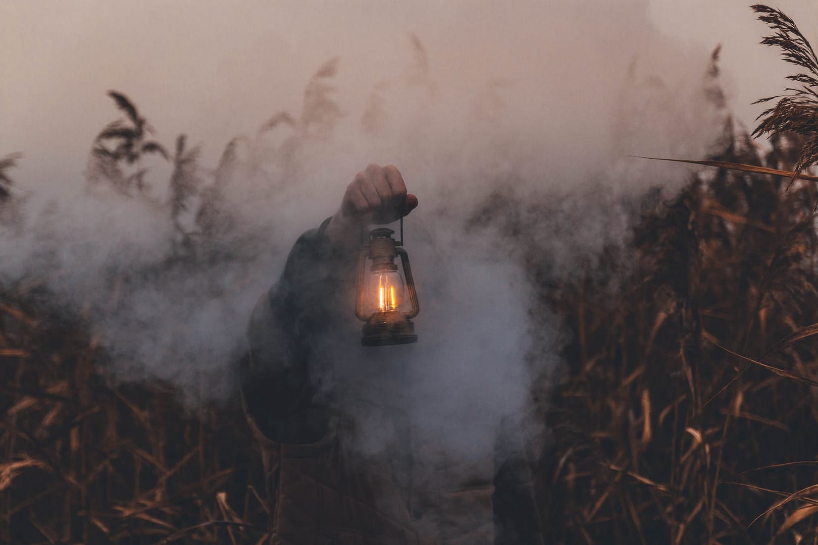 person holding kerosene lantern
