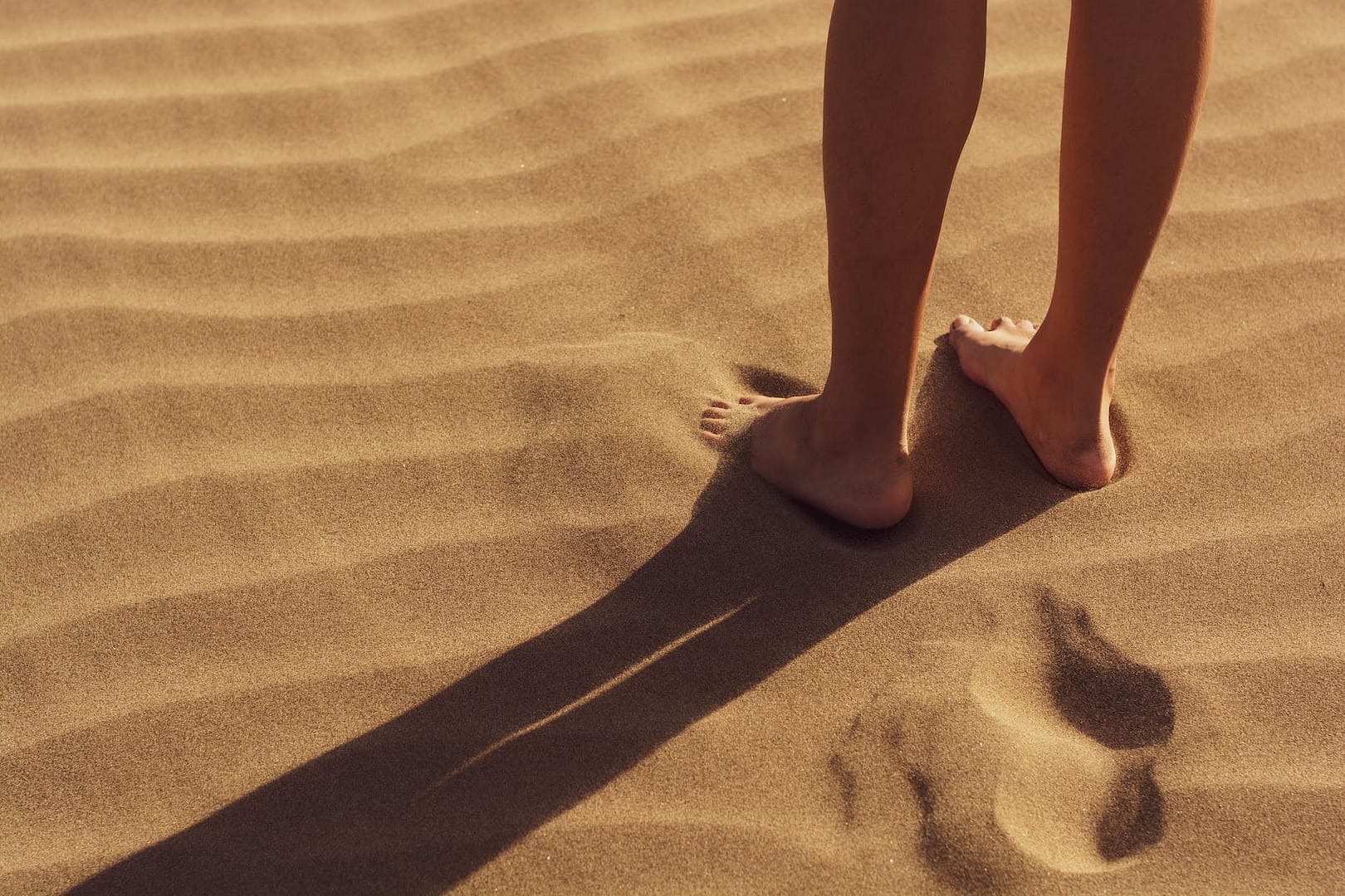 person stand on sand