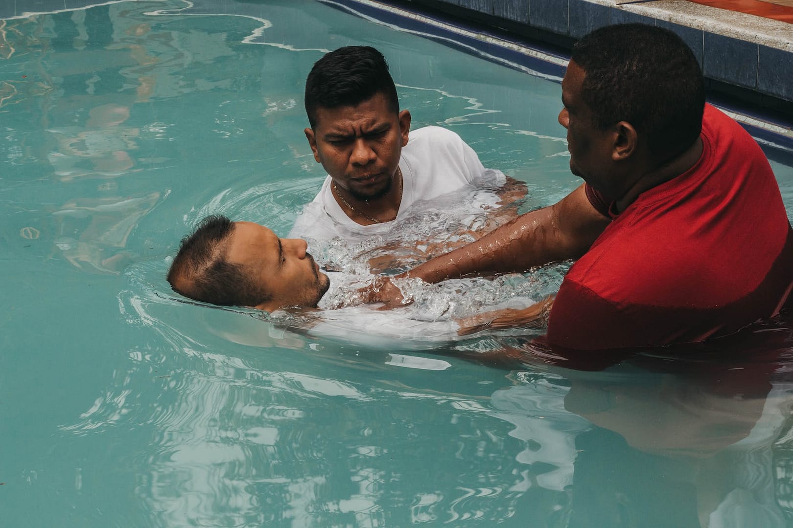 a man doing christian baptism on the water