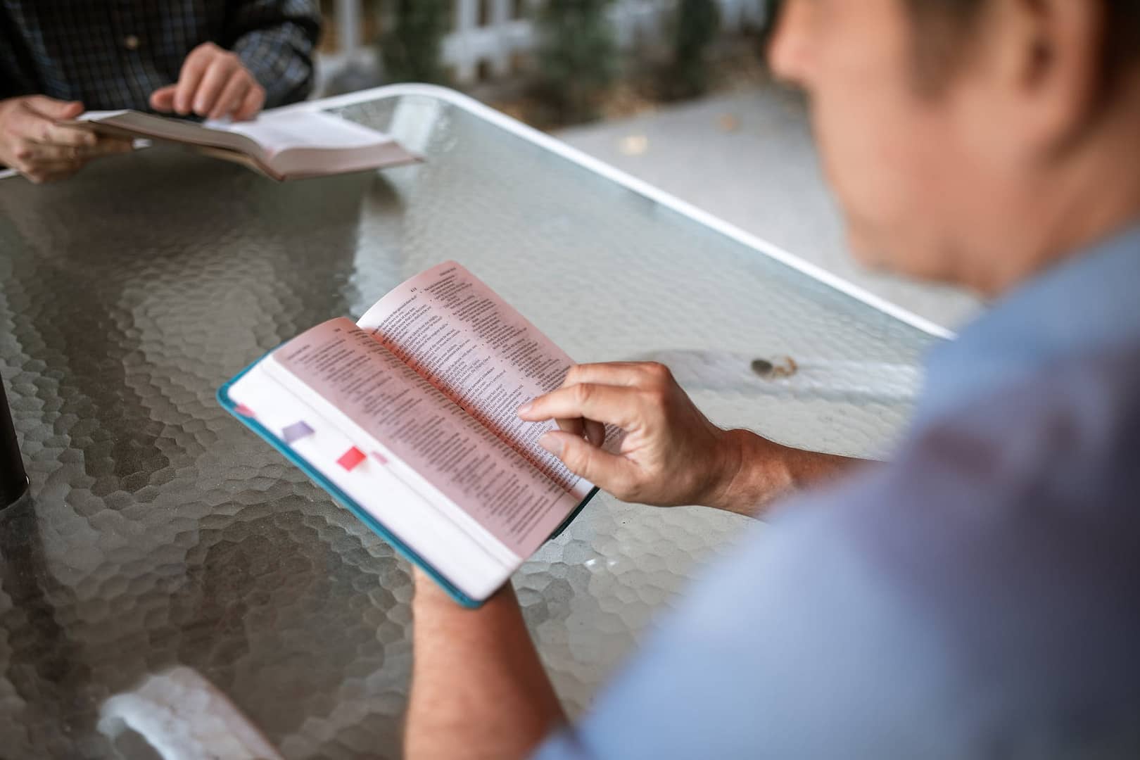 person holding white and red book