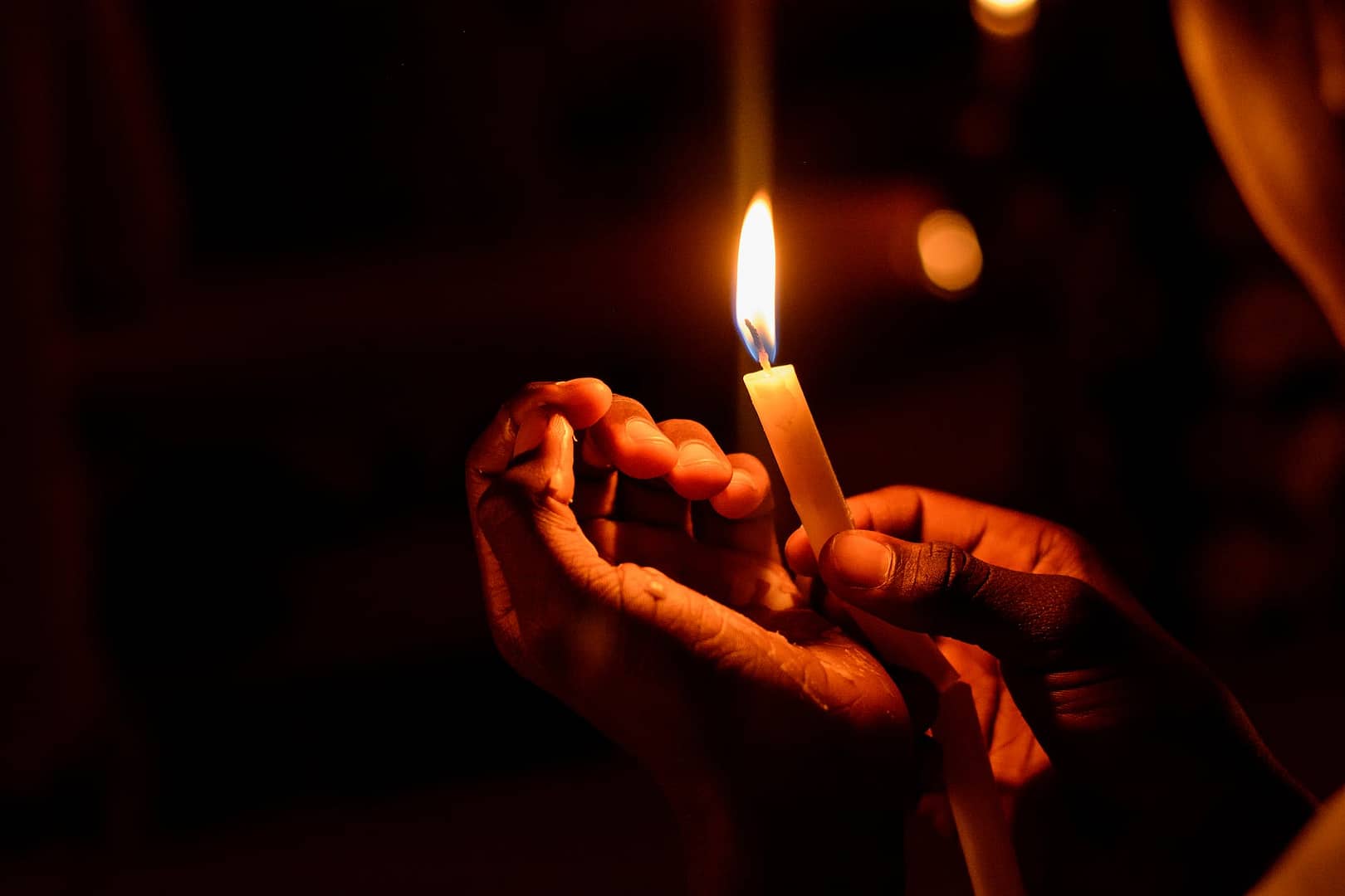 person holding lighted candle