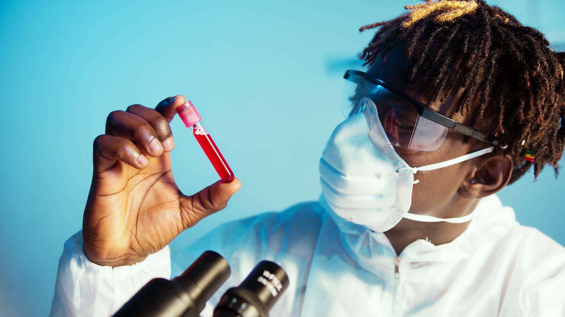 a man holding a blood tube